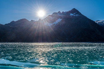 Broken pieces of ice floating in the lake through the Glacier Bay National Park and Preserve...