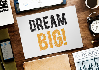 Flat lay of Dream big on white paper