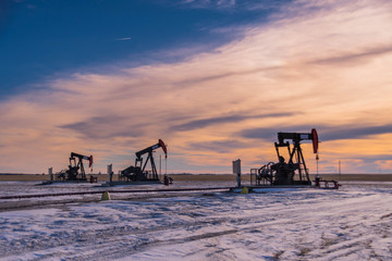 Fototapeta na wymiar Oil Derrick on the Prairies in Winter 