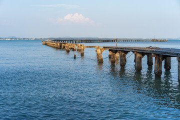 Fototapeta na wymiar broken wooden bridge to sea (damage from storm) at Rayong,Thailand