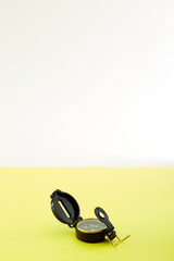 Naklejka premium Minimal Compass on bright yellow background