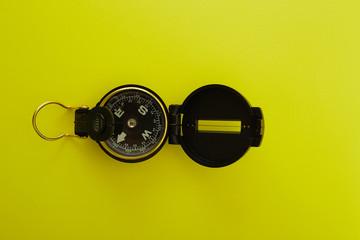 Obraz na płótnie Canvas Minimal Compass on bright yellow background