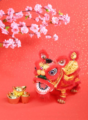 Fototapeta premium chinese traditional dancing lion with Gold ingot,Chinese calligraphy Translation:good bless for money
