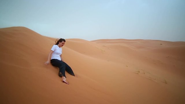 Handsome girl brunette lost in the very windy desert of sahara 