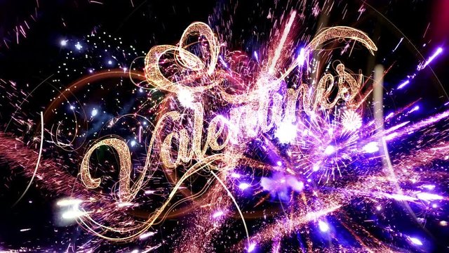Valentines day text magic fireworks with particles and sparks on black night sky in slow motion with colorful fireworks, beautiful greeting typography  design.