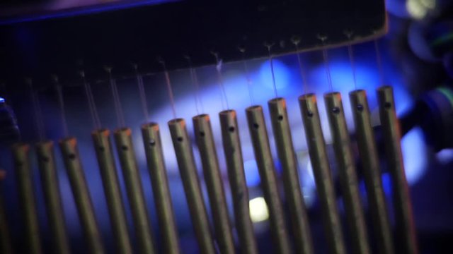 Close-up of a wind chime percussion instrument on stage at a live concert as the drummer drags his stick along the tubes to make music