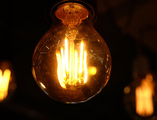 Ceiling lamps on dark background in store, close up
