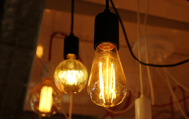 Ceiling lamps on dark background in store, close up