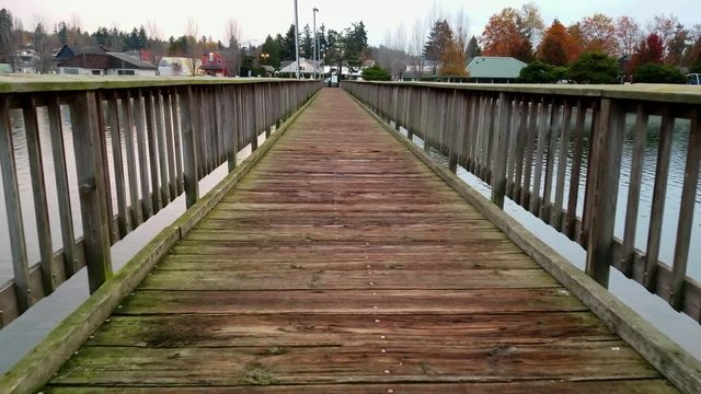 Walking down a wooden pier on an overcast autumn day in silverdale washington