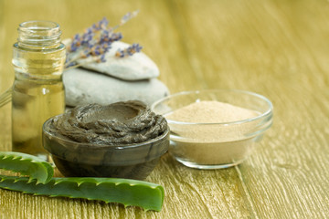 Preparing cosmetic mud mask with aloe vera, lavender, essential oil. facial clay with spa products stones. Natural cosmetics for home or salon treatment. white clay powder, black cosmetic clay