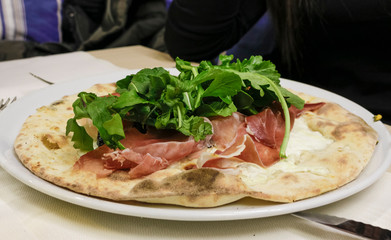 pizza with quinoa flour, raw ham and mozzarella