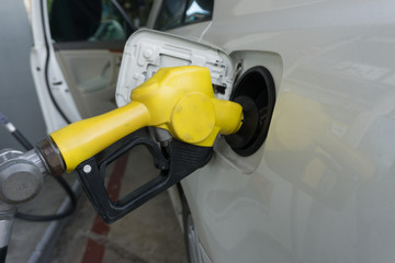 Refueling gasoline fuel in car at gas station