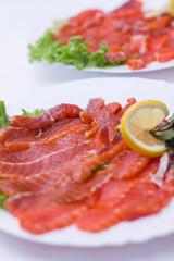 salmon with lemon on a white plate