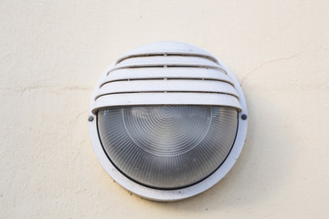 Lighting and illumination concept - A solitary lamp on a white textured wall