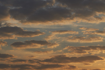 Beautiful sky full of clouds and the evening sun light.