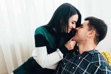 Young pretty couple spend time together at cozy home