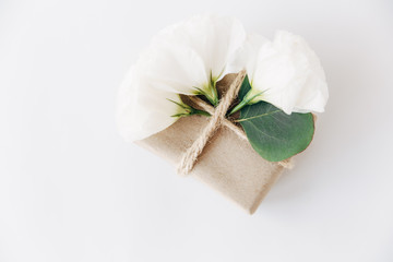 white flowers and stylish craft present box.top view.creative minimalist composition.valentines day,romantic and love concept