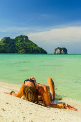 Fototapeta na wymiar Woman enjoying her holidays on the beach