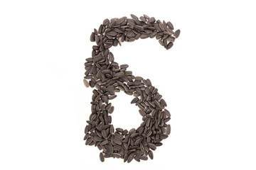 Numerals from black sunflower seeds isolated on white background.