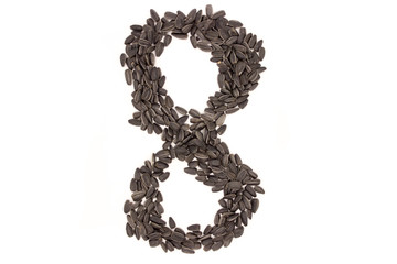 Numerals from black sunflower seeds isolated on white background.