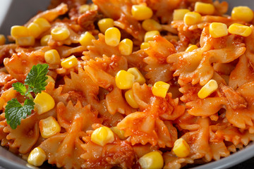 Italian pasta farfalle with tuna, corn and tomato sauce
