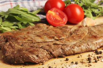 A beef steak well done with vegetables