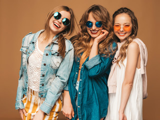 Three young beautiful smiling hipster girls in trendy summer casual jeans clothes. Sexy carefree...