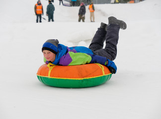 people have fun riding the snow slides on the tubing.