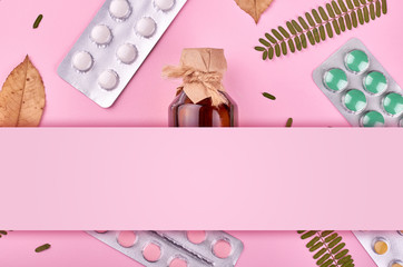 Medicine background - pharmacy. Pharmaceutical pills on pink backdrop. Flat lay image