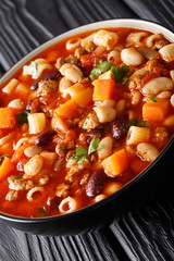 Pasta fagioli soup close-up in a bowl. vertical