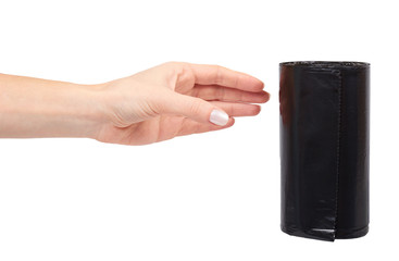 hand with roll of black plastic garbage bags for trash