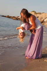 Fototapeta na wymiar portrait of Happy nice Mother and small daughter near sea