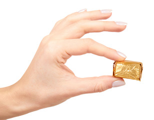 Fototapeta premium Hand with chocolate candy, sweet dessert closeup