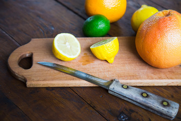 citrus fruits (grapefruit, orange, lemon, lime), on the wooden background.
