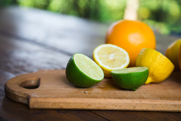 citrus fruits (grapefruit, orange, lemon, lime), on the wooden background.