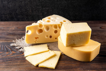 Cheese on dark wooden background.