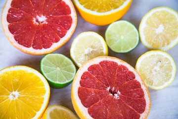 citrus fruits (grapefruit, orange, lemon, lime), on the wooden background.
