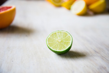 citrus fruits (grapefruit, orange, lemon, lime), on the wooden background.