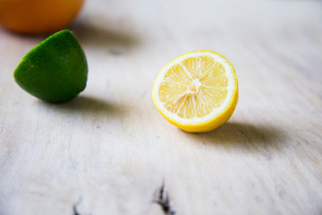 citrus fruits (grapefruit, orange, lemon, lime), on the wooden background.