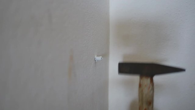 Hand close up of a man to drilling concrete and tighten screw for install water pipe in kitchen room