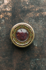 Dried saffron spice on dark background.