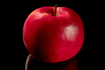 red Apple on black background with reflection
