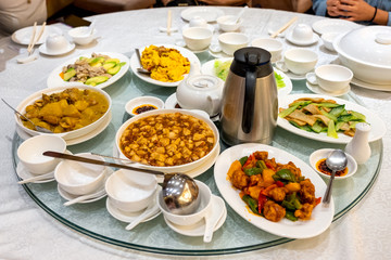 Variety asian food serving with tea preparing on glass round table