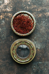 Obraz na płótnie Canvas Dried saffron spice on dark background.