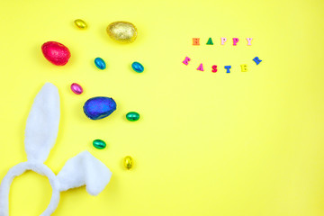 Easter decoration eggs cute bunny on yellow background. Happy Easter. Top view aerial image of decoration symbol