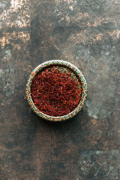 Dried saffron spice on dark background.