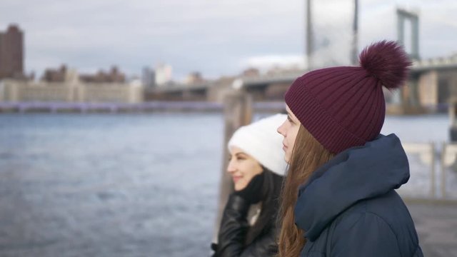 Two girls on a sightseeing tour to New York City at Hudson River