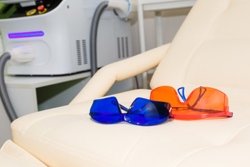 Eye protection goggles during laser hair removal. One pair of goggles in different colors.