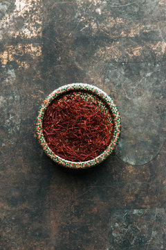 Dried saffron spice on dark background.