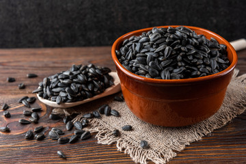 Sunflower seeds on wooden background.